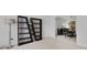 Open-concept living room leading to a dining area, enhanced by stylish bookshelves and ample lighting at 2584 Grayton Loop, Villa Rica, GA 30180
