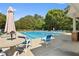A sparkling community pool with lounge chairs, umbrellas, and lush landscaping at 2584 Grayton Loop, Villa Rica, GA 30180