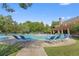 Community pool with lounge chairs, a bath house and mature trees, offering a great outdoor experience at 2584 Grayton Loop, Villa Rica, GA 30180