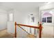 A view of the upstairs foyer that has a wooden staircase and lots of natural light at 2584 Grayton Loop, Villa Rica, GA 30180