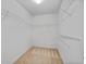 Walk-in closet with carpet flooring and ample built-in shelving for storage at 2584 Grayton Loop, Villa Rica, GA 30180