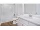 Bathroom features a combination tub and shower, modern vanity, and wood-look flooring at 2681 Lakeside Sw Dr, Conyers, GA 30094