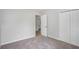 Bedroom with closet and entry doors featuring neutral carpeting and gray walls at 2681 Lakeside Sw Dr, Conyers, GA 30094