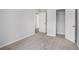 Bedroom with neutral carpet offers an open closet and doorway, showing interior space at 2681 Lakeside Sw Dr, Conyers, GA 30094