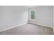 Bedroom with gray walls and neutral carpeting, lit by a window, offering a serene space at 2681 Lakeside Sw Dr, Conyers, GA 30094