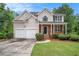 Charming two-story home with a well-manicured lawn and a two-car garage at 2681 Lakeside Sw Dr, Conyers, GA 30094
