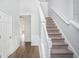 Bright foyer with staircase, hardwood floors, and elegant wainscoting detail at 2681 Lakeside Sw Dr, Conyers, GA 30094