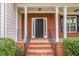 Inviting front porch with brick columns and stairs leading to the front door at 2681 Lakeside Sw Dr, Conyers, GA 30094