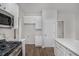 Modern kitchen with white cabinets, stainless appliances, laminate floors, and an island at 2681 Lakeside Sw Dr, Conyers, GA 30094