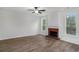 Cozy living room featuring a fireplace with brick surround and natural light from the windows at 2681 Lakeside Sw Dr, Conyers, GA 30094