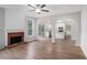 Inviting living room with hardwood floors, fireplace, and open access to a modern kitchen at 2681 Lakeside Sw Dr, Conyers, GA 30094