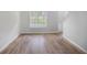Bright living room with laminate floors and a large window at 2681 Lakeside Sw Dr, Conyers, GA 30094
