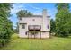 Expansive two-story home featuring a deck and a spacious backyard with lush green grass at 2681 Lakeside Sw Dr, Conyers, GA 30094