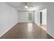 Bright bedroom with a ceiling fan, hardwood floors, and a view of the trees through a window at 3924 Chimney Ridge Ct, Ellenwood, GA 30294