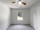 Clean bedroom with a ceiling fan, carpeted floors, and a view of the neighborhood through a window at 3924 Chimney Ridge Ct, Ellenwood, GA 30294