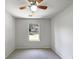 Bright bedroom with a ceiling fan, neutral walls, and view of the neighborhood through a window at 3924 Chimney Ridge Ct, Ellenwood, GA 30294