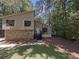 Inviting exterior of a two-story home with stone accents and mature trees at 3924 Chimney Ridge Ct, Ellenwood, GA 30294