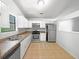 Well-lit kitchen with stainless steel appliances, neutral countertops, and tile flooring at 3924 Chimney Ridge Ct, Ellenwood, GA 30294