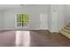 Spacious living room showcasing ample natural light and staircase at 3924 Chimney Ridge Ct, Ellenwood, GA 30294