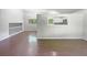 Open-concept living room with hardwood floors and a view to the kitchen at 3924 Chimney Ridge Ct, Ellenwood, GA 30294