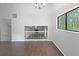 Bright, spacious living room with hardwood floors and large window looking out to a treed backyard at 3924 Chimney Ridge Ct, Ellenwood, GA 30294