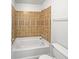 Shower and toilet area featuring earthy-toned tiles at 3924 Chimney Ridge Ct, Ellenwood, GA 30294