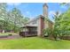 Spacious backyard featuring a large deck, tall chimney and a lush green lawn perfect for outdoor living at 9048 River Bend Ct, Villa Rica, GA 30180