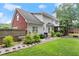 Landscaped backyard with well-maintained lawn, brick accents, and privacy fence offer a serene outdoor space at 9048 River Bend Ct, Villa Rica, GA 30180