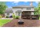 An exterior elevation view of the house, deck, patio, and backyard at 9048 River Bend Ct, Villa Rica, GA 30180