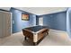 Finished basement featuring a pool table with an accent picture for an eye-catching design at 9048 River Bend Ct, Villa Rica, GA 30180