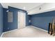 Finished basement space with blue walls and durable flooring for a clean open area at 9048 River Bend Ct, Villa Rica, GA 30180