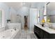 Bright bathroom with a soaking tub, double vanity, and glass shower in a well lit space at 9048 River Bend Ct, Villa Rica, GA 30180