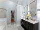 Bright bathroom with double vanity, glass enclosed shower and view to the walk-in closet at 9048 River Bend Ct, Villa Rica, GA 30180