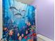 Bathroom showcasing a colorful fish-themed shower curtain next to the toilet at 9048 River Bend Ct, Villa Rica, GA 30180