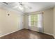 Comfortable bedroom featuring hardwood floors, a ceiling fan, and ample natural light at 9048 River Bend Ct, Villa Rica, GA 30180