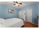 This bedroom features light blue walls, hardwood floors, a ceiling fan, and two closets at 9048 River Bend Ct, Villa Rica, GA 30180