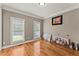 Bright bedroom with hardwood floors, two windows, and neutral paint color at 9048 River Bend Ct, Villa Rica, GA 30180