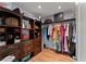 Walk-in closet features custom shelving, hanging racks, and hardwood floors at 9048 River Bend Ct, Villa Rica, GA 30180