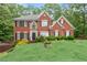 Beautiful red brick home featuring classic architectural details and a well-maintained landscape at 9048 River Bend Ct, Villa Rica, GA 30180