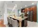 The kitchen features a large center island, stainless steel appliances, and stylish pendant lighting at 9048 River Bend Ct, Villa Rica, GA 30180