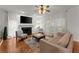 Cozy living room features a fireplace, hardwood floors, natural light, and neutral paint colors at 9048 River Bend Ct, Villa Rica, GA 30180