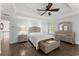 Well-lit bedroom with tray ceilings, hardwood floors, and large windows overlooking the greenery at 9048 River Bend Ct, Villa Rica, GA 30180