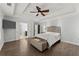 Spacious bedroom with tray ceilings, hardwood floors, and neutral decor to create calm space at 9048 River Bend Ct, Villa Rica, GA 30180
