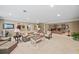 Large finished basement with neutral colors, a cozy seating area, and adjacent bar at 162 Daltree Ct, Marietta, GA 30068