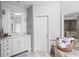 Bright bathroom featuring marble counters, custom cabinets, and a framed mirror with a decorative chandelier reflection at 162 Daltree Ct, Marietta, GA 30068