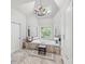 Beautiful bathroom featuring a soaking tub under a chandelier and a stained glass window accent at 162 Daltree Ct, Marietta, GA 30068