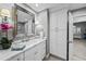 Bright bathroom featuring a marble countertop vanity, a large mirror, and abundant storage cabinets at 162 Daltree Ct, Marietta, GA 30068