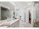 Lavish bathroom with a glass shower, soaking tub, dual vanities, and white cabinets at 162 Daltree Ct, Marietta, GA 30068