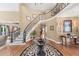 Elegant foyer with a curved staircase, hardwood floors, and sophisticated decor, creating a grand entrance at 162 Daltree Ct, Marietta, GA 30068