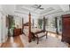 Luxurious main bedroom with tray ceilings, hardwood floors, and access to a private balcony at 162 Daltree Ct, Marietta, GA 30068